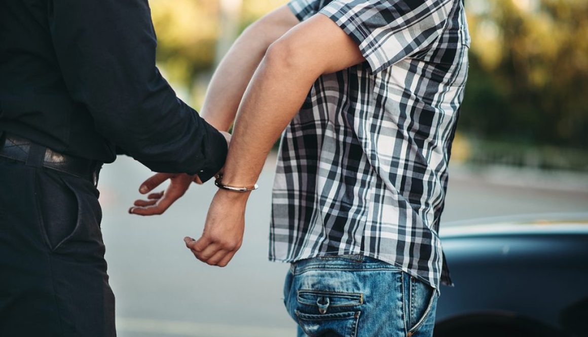 Officer Arresting a Man for Drunk Driving